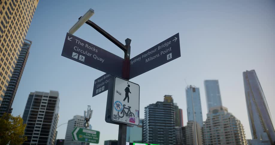 A street sign is near the buildings