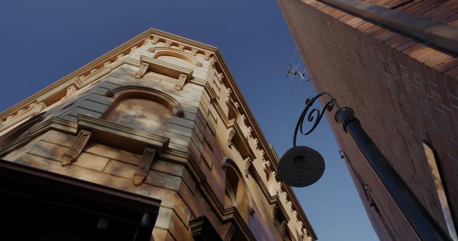Upward view of a brick building on a cloudless blue sky day