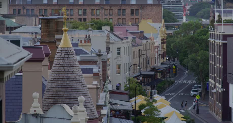 City roofs with people crossing the street below