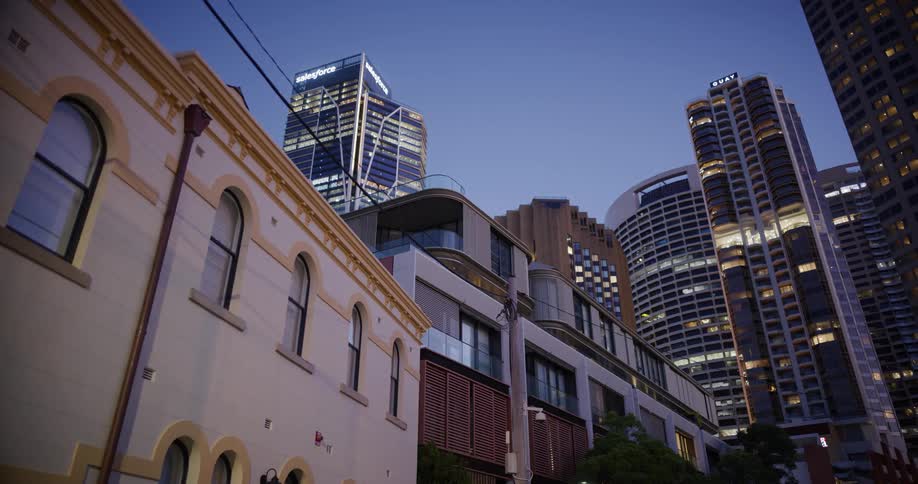 Metropolitan city with skyscrapers and buildings illuminated at dusk