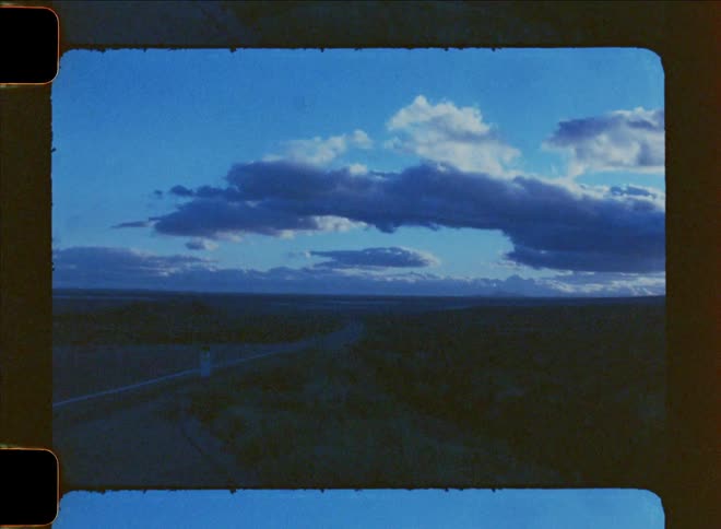 Highway in a place with desert vegetation on a blue sky day with clouds