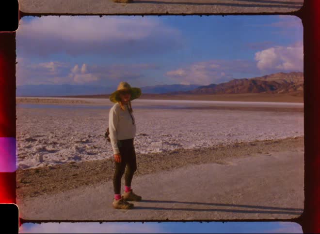 A film clip of a lady posing in the desert
