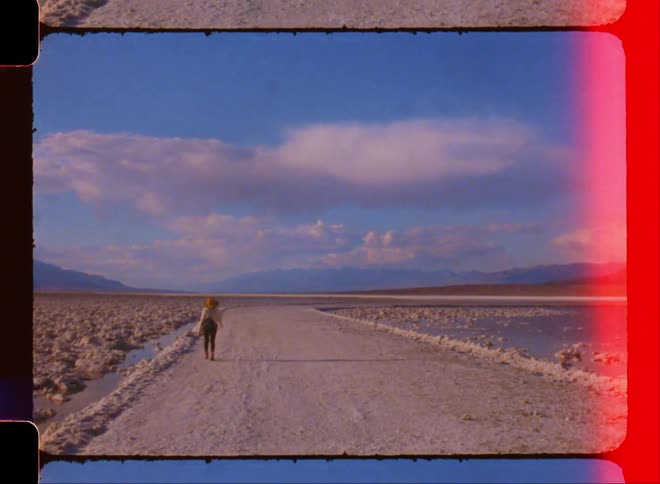A film footage of the back of a woman walking away