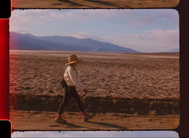 A woman hikes down the desert trail
