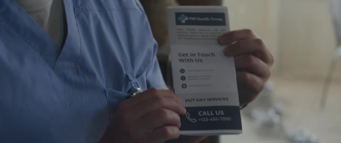 A male nurse explaining the contents of a brochure