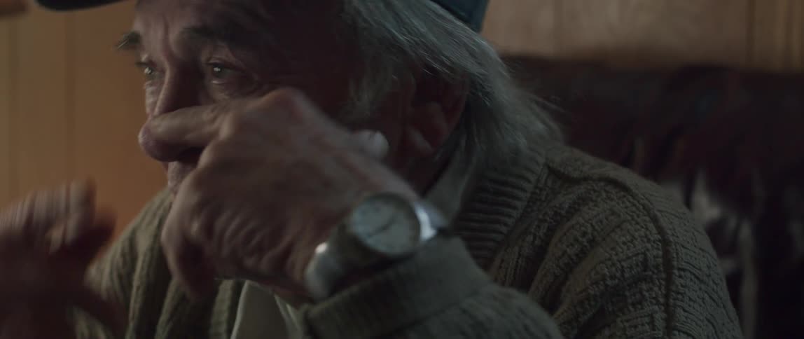 A face of an elderly man who is talking