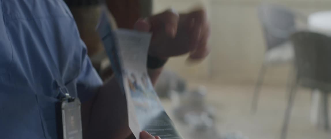 Hands of a doctor showing a pamphlet
