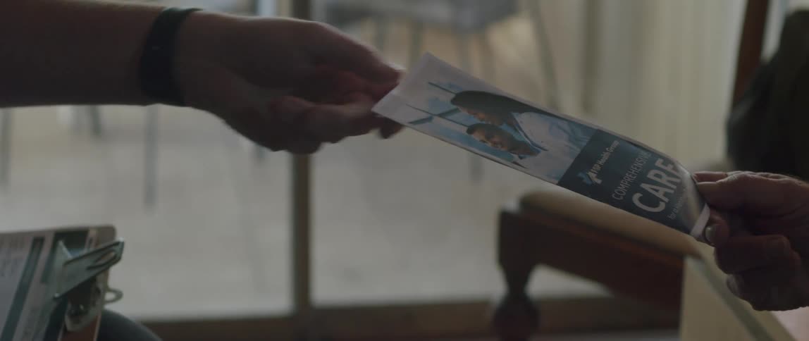 Hand of a person handing another a pamphlet