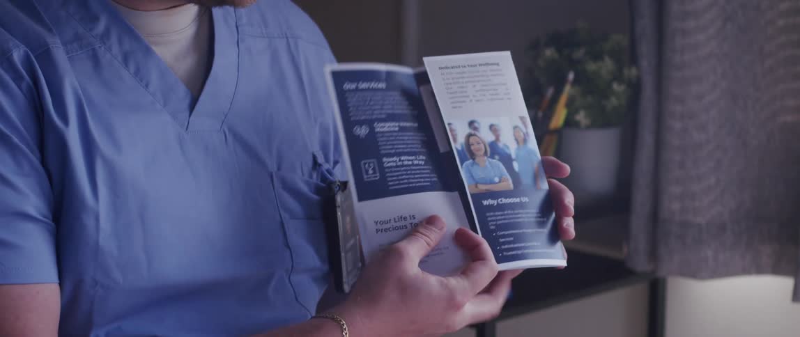 A doctor presents a panflet for an assisted living facility