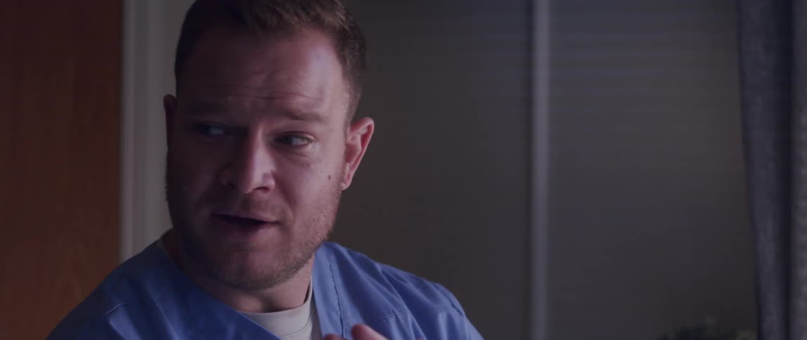 Portrait of a doctor talking and presenting a pamphlet in his hand