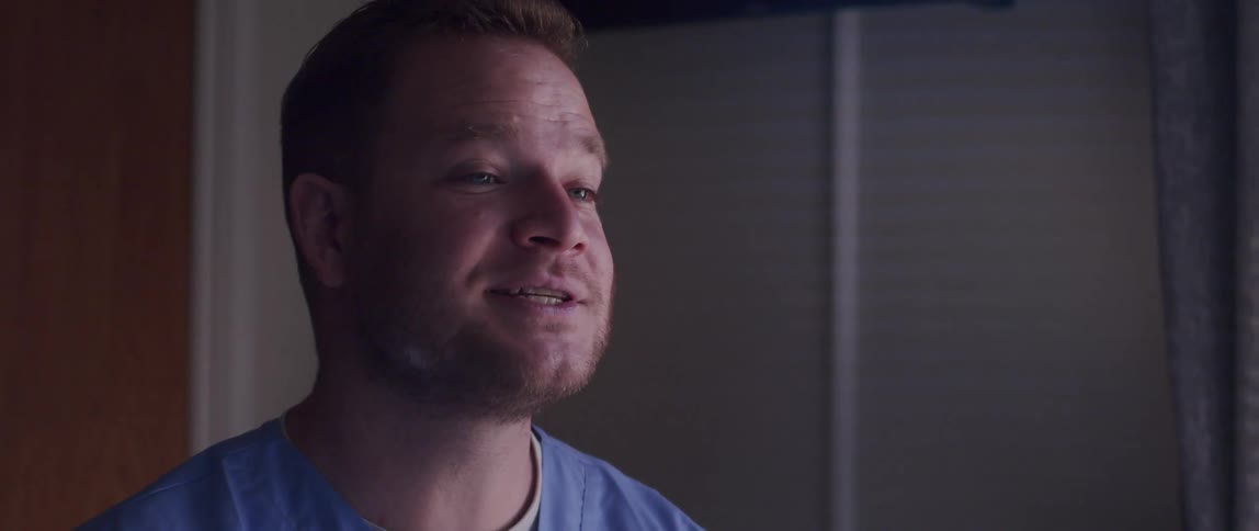 A male nurse talks jokingly with his patient and then leaves the room