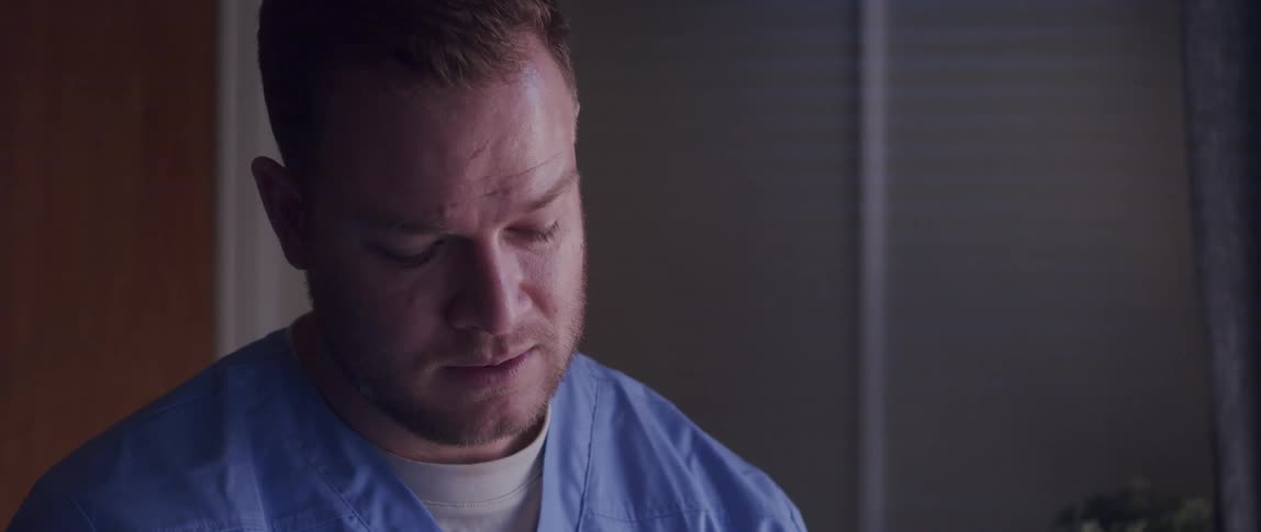A male nurse discusses medical issues with a patient