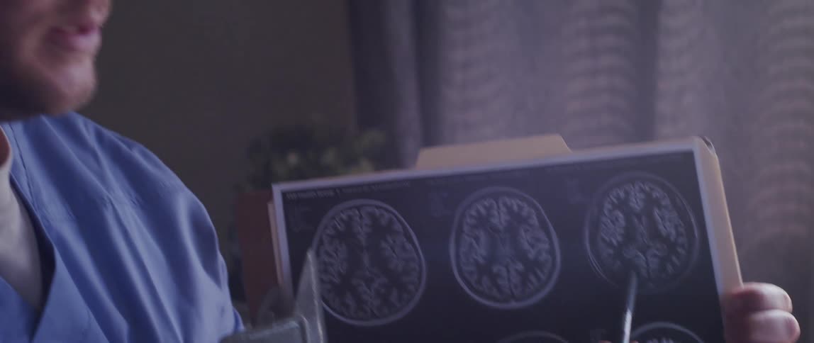 A healthcare worker explains a brain condition