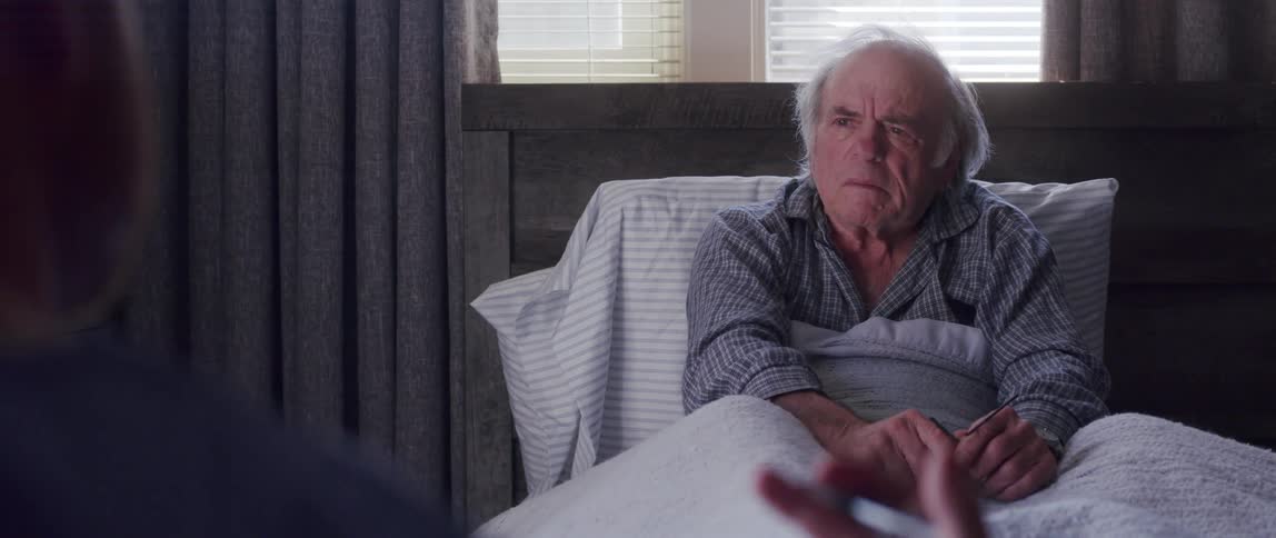 An old man having a conversation with another person