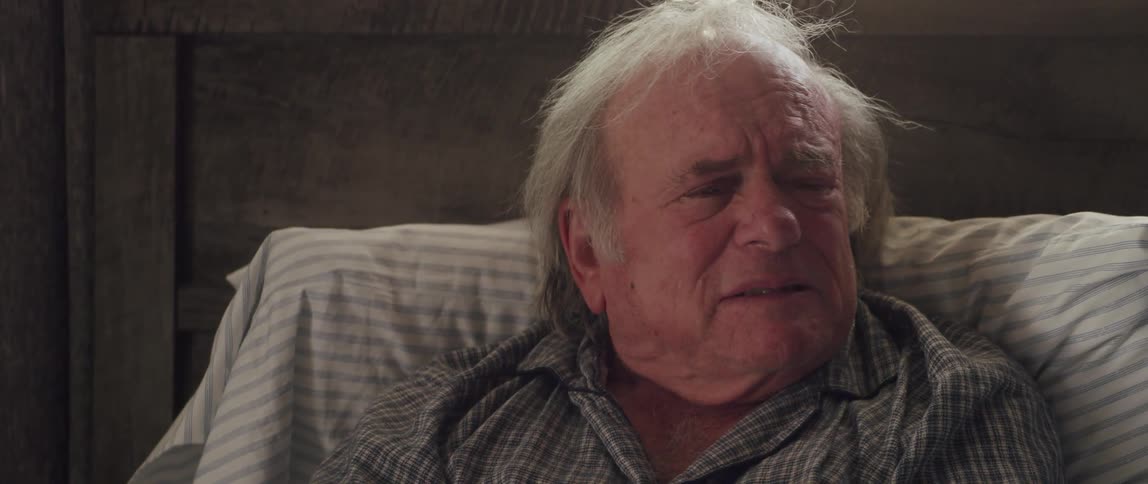 Portrait of an elderly man with teary eyes and talking with despondency