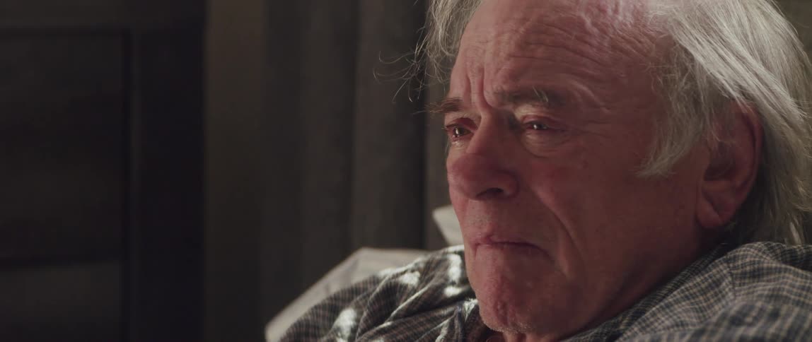 The face of an elderly man who is sad and crying