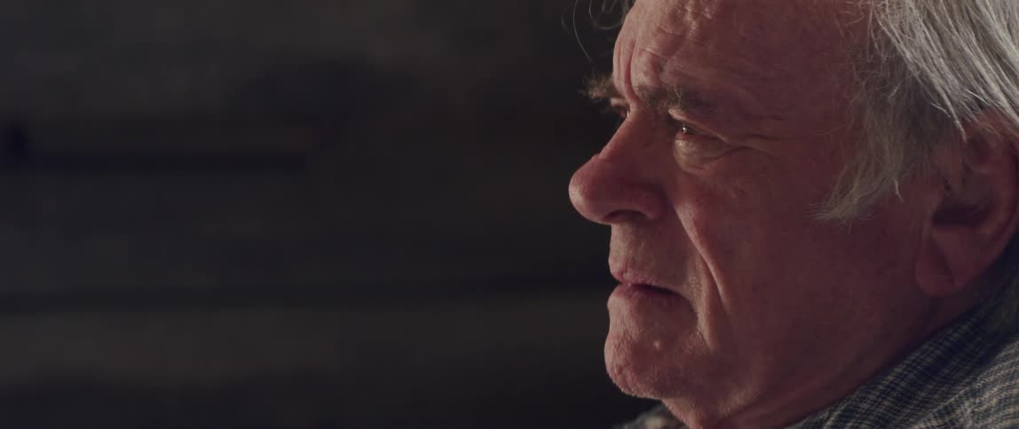 An old man takes off his glasses and starts to cry and sob