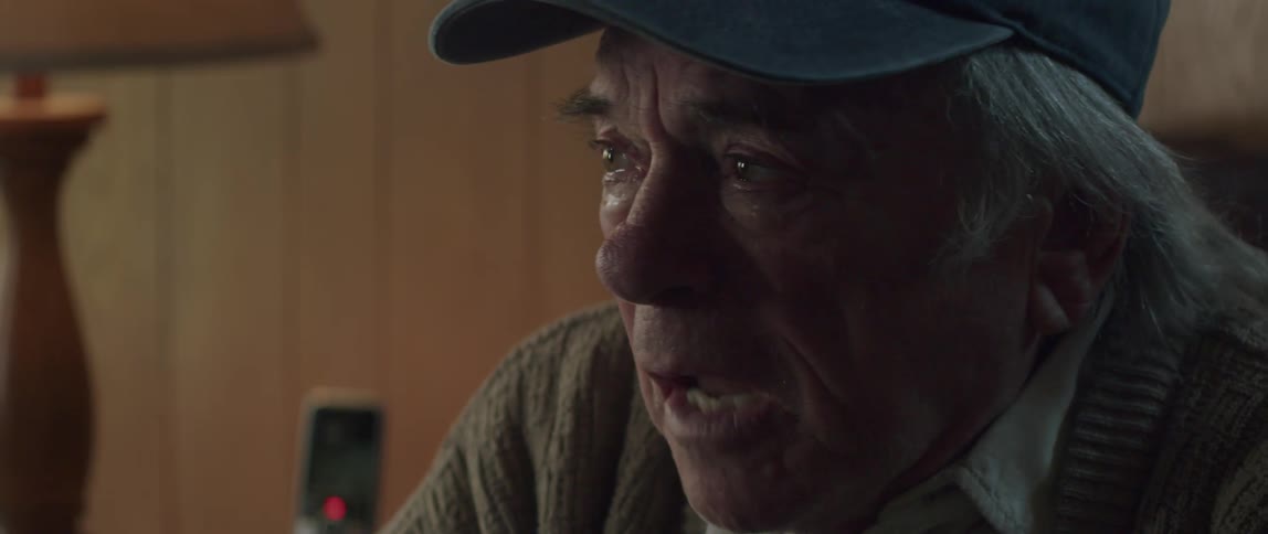 Portrait of an elderly man crying while talking
