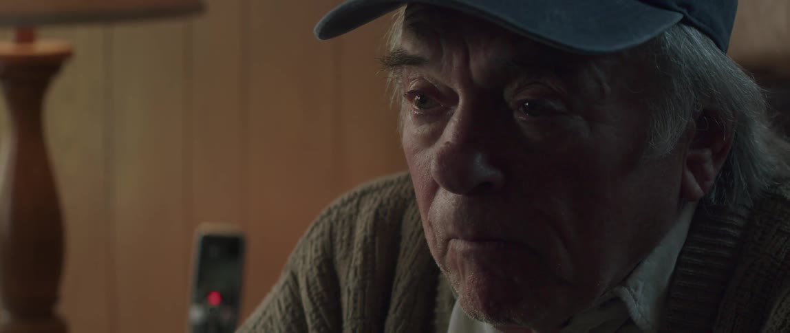 Portrait of an elderly man with eyes watering with sadness talking