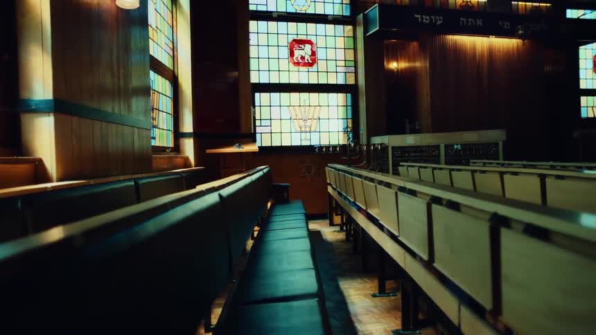 Interior of a church with leather pews windows with arts and solar reflections