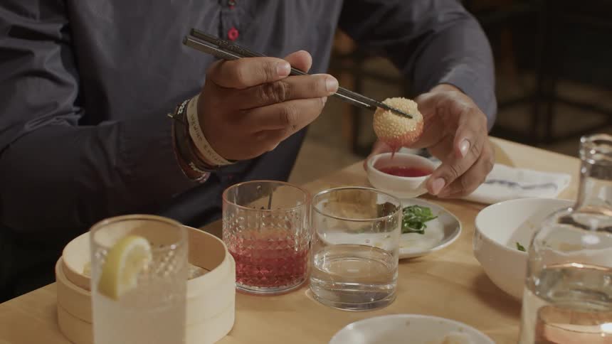 Three people have a meal in a restaurant