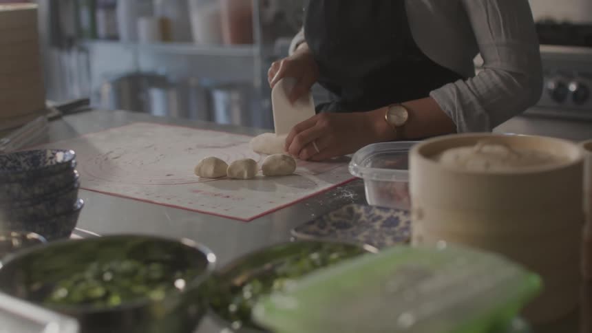 A woman prepares food in a restaurant