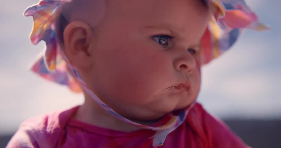 Portrait of a lighteyed baby with little sun hat