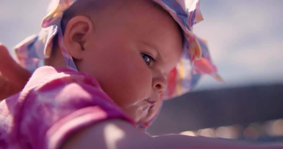 A father pats the back of his baby daughter