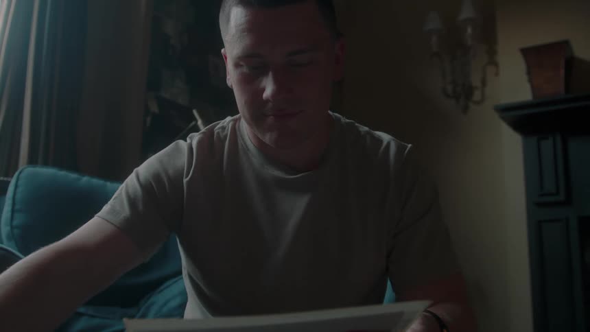 A man sits in a chair and reads