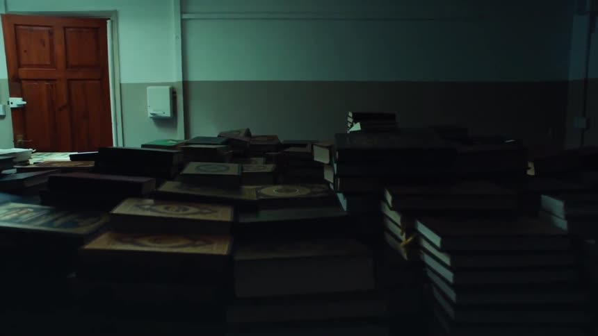 Several stacks of books in a room
