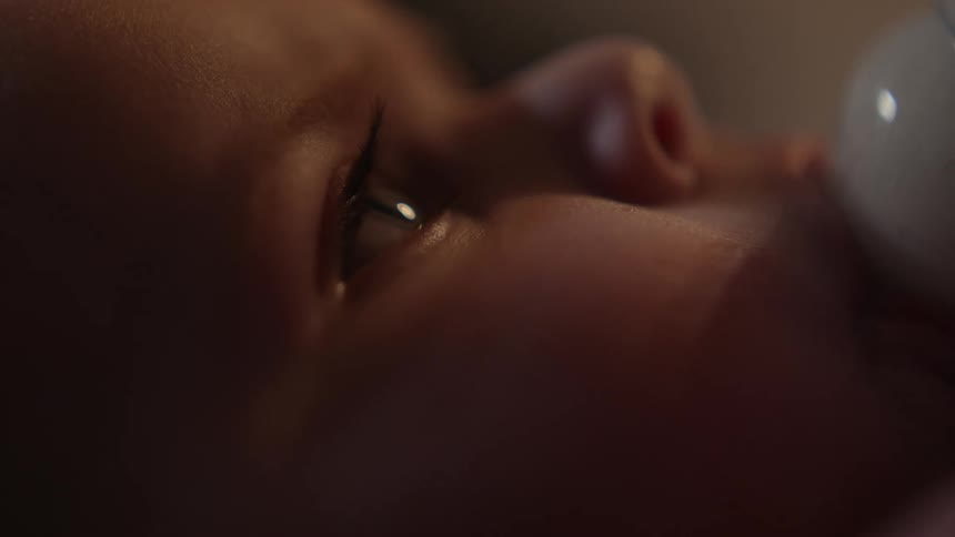 A baby with an object in its mouth