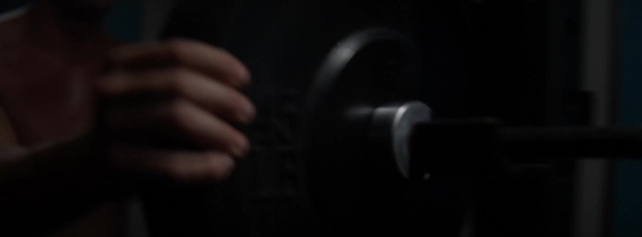 A man is loading weights on a barbell