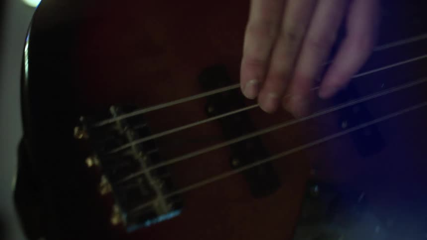 A close up clip of a person playing a guitar