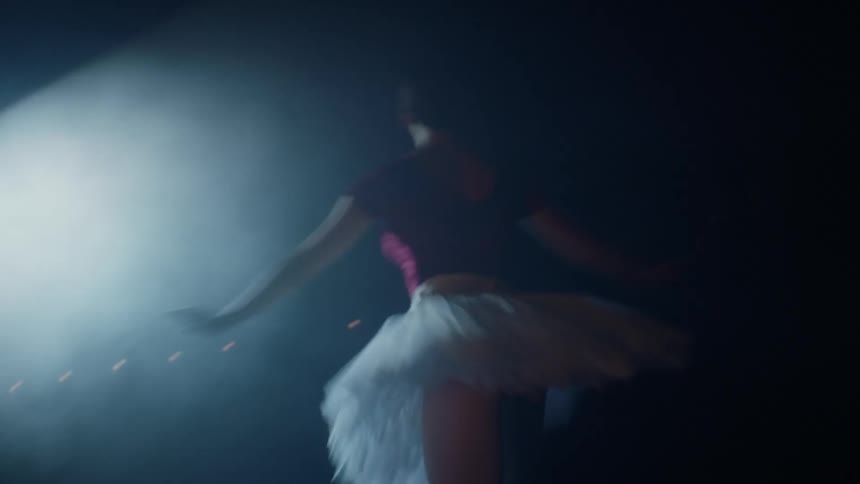 A woman performs ballet on a stage