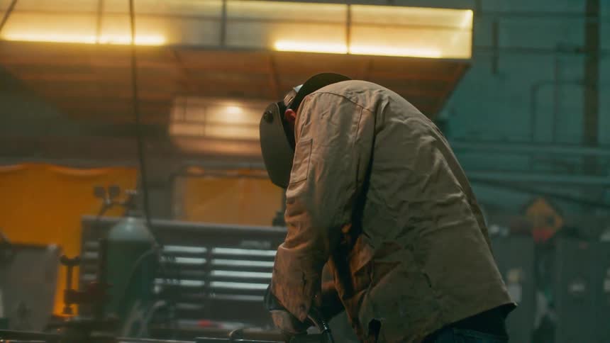 A man uses a welding torch