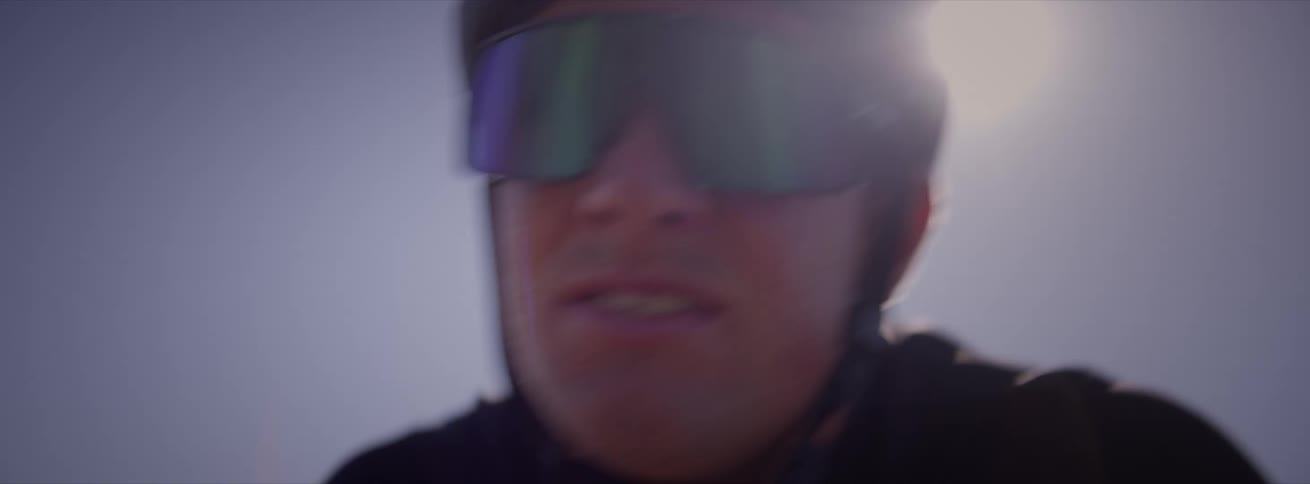 A man cycling with a determined look on his face