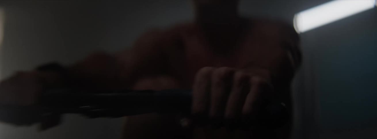 Man performing cardio on a flywheel pulling machine indoors