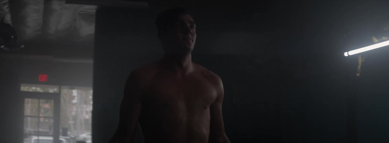 Man jumping rope in a room with low lighting
