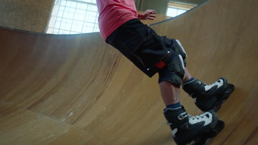 A man skating at an indoor skate park