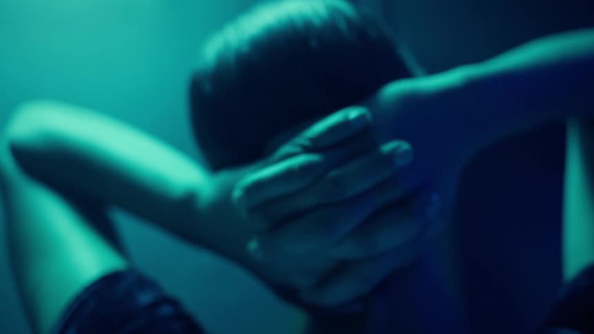 A woman holds her hair bun