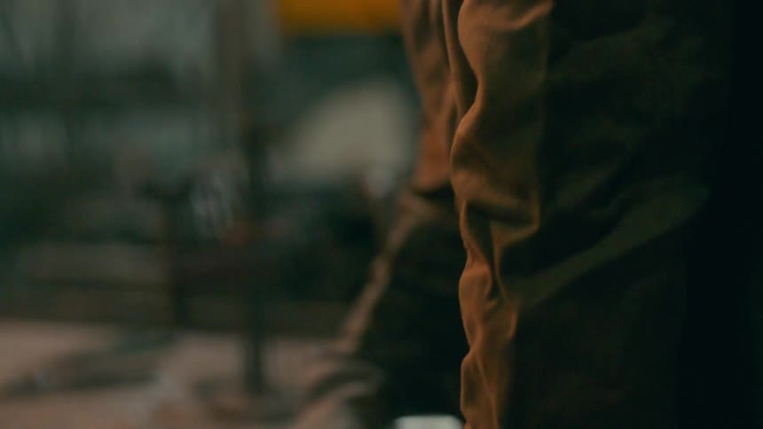 Man dressed in a protective jacket and gloves while indoors