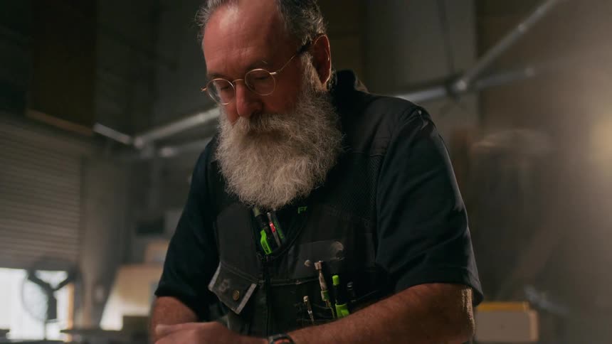 A bearded man working on his garage