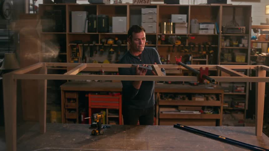 A carpenter in his workshop building a wood table