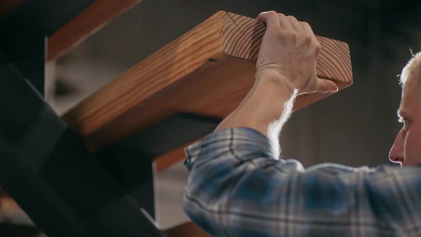 A clip of an old man working on a wood