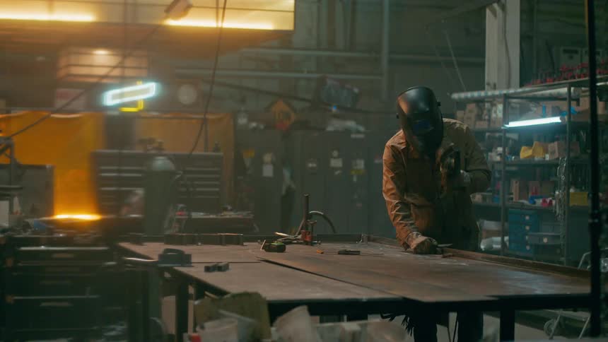 A man is welding in his shop