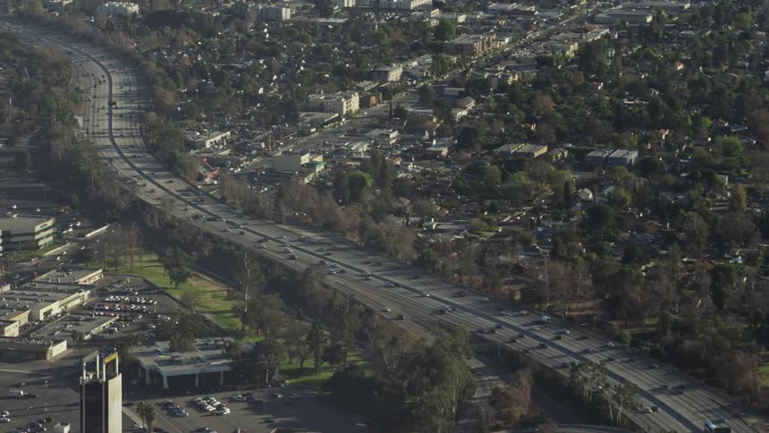 Cars travel on the highway separating the city and the suburbs
