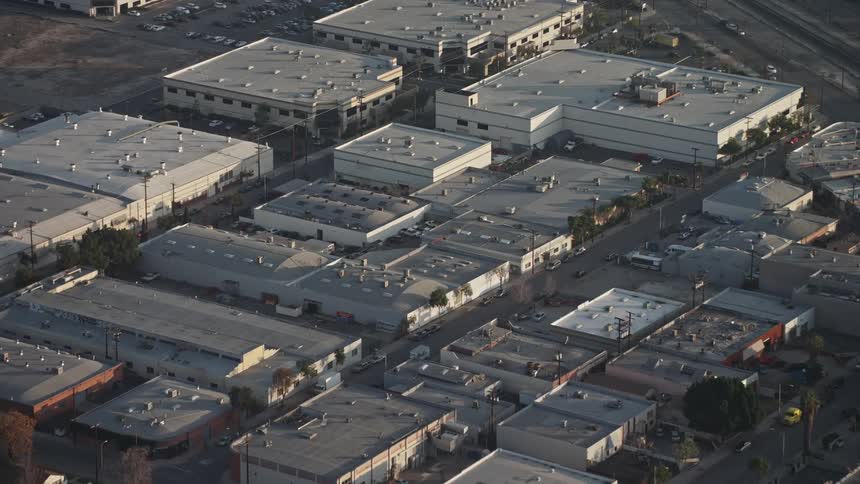 Aerial panorama of uno residential neighborhood next to clusters of factories