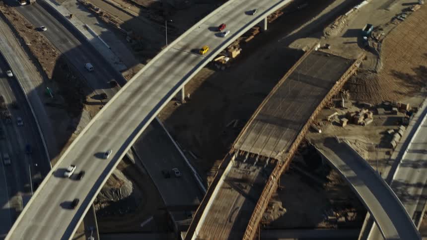 Traffic moves along highways in a suburban area