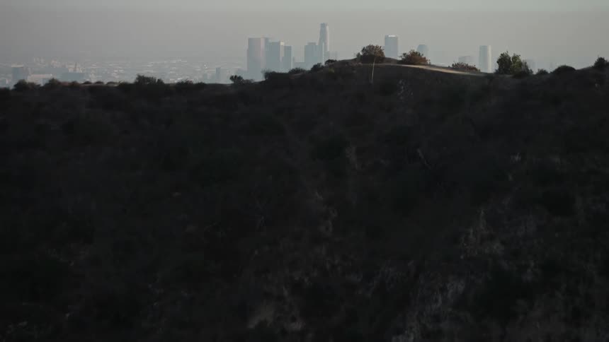 Aerial view of the city of los angeles behind the hills