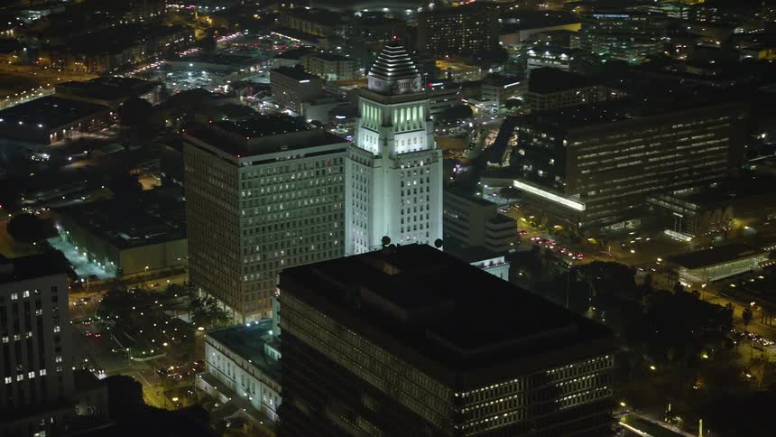 Numerous buildings are brightly illuminated in this metropolitan city